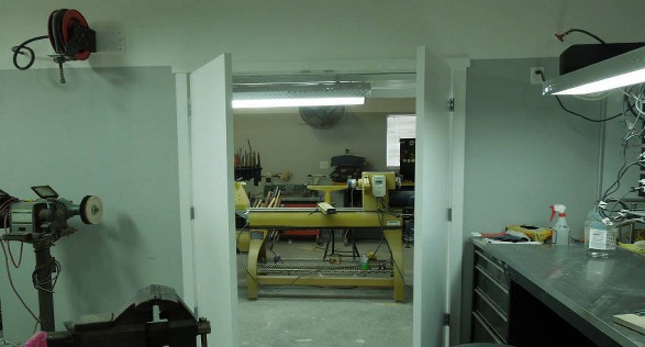 The dust created while sanding is a nightmare and gets into EVERYTHING. So, I created a room where the lathe and the stationary sanding machines are separate from the main shop. There is a large hood over the lathe connected to a large fan and other dust collection devices connected to a large vacuum dust collection system.
