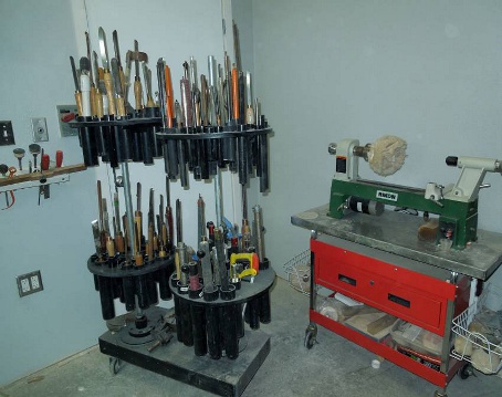 Rotary tool rack made from plywood, pvc pipe and the rotors and hubs from an old boat trailer. This allows the substantial weight of the tools ride on tapered roller bearings.