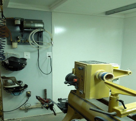 The vacuum pump mounting and safety gear nestled in potted plant hangers 